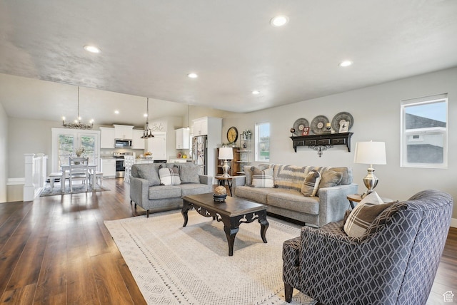 living room with dark wood-style flooring, a chandelier, recessed lighting, and baseboards