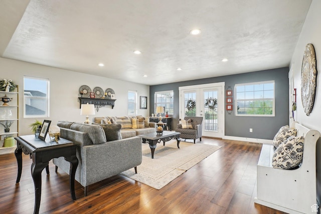 living room featuring dark wood finished floors, recessed lighting, french doors, and baseboards