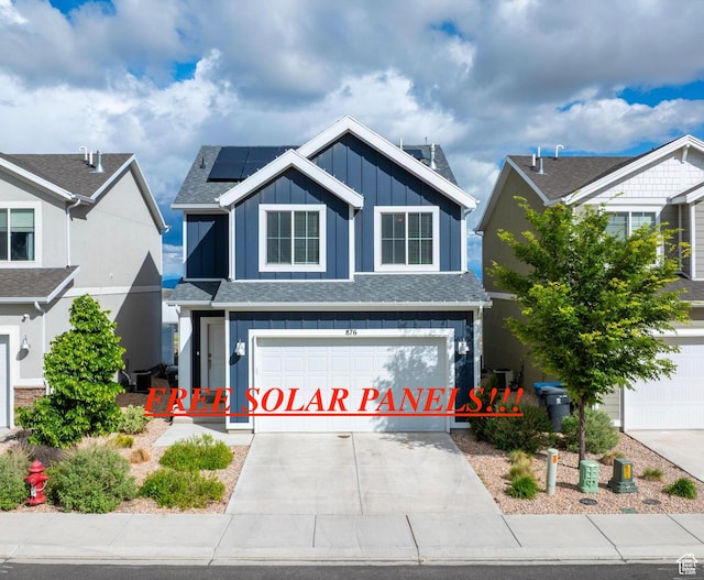876 S Brubaker Way, Santaquin, UT 84655 - view of front of house with board and batten siding, a garage, roof mounted solar panels, and concrete driveway