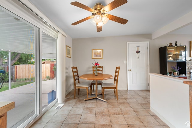 dining space featuring ceiling fan, baseboards, and light tile patterned flooring