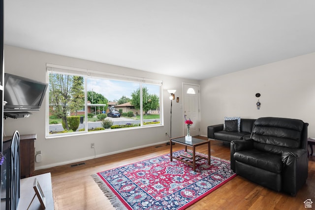 living room with wood finished floors and baseboards
