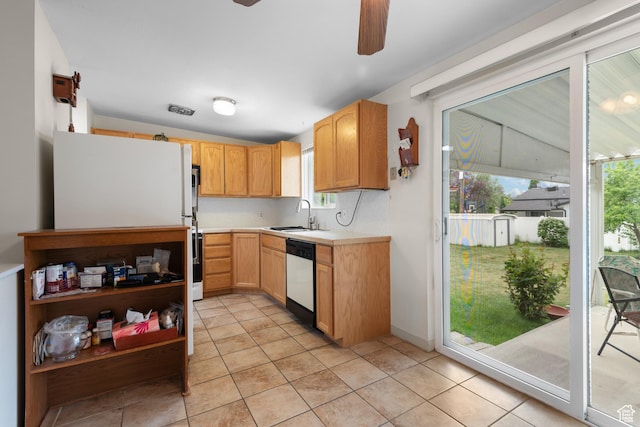 kitchen with white dishwasher, a sink, a ceiling fan, light countertops, and light tile patterned floors