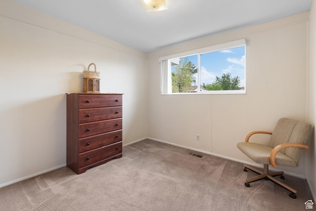 sitting room featuring light carpet and baseboards