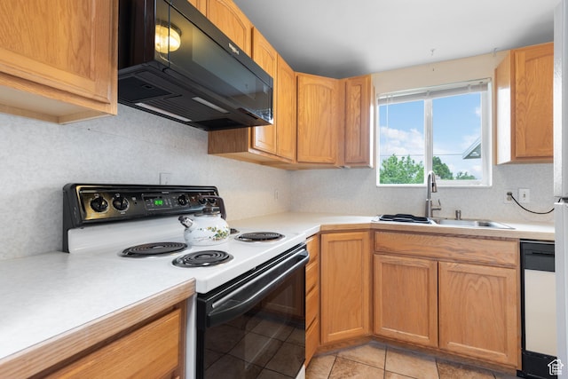 kitchen featuring electric stove, black microwave, a sink, and light countertops