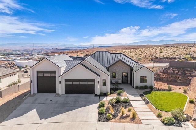 1003 N Grand Heights Dr, St George, UT 84770 - modern inspired farmhouse featuring an attached garage, a mountain view, driveway, and stucco siding