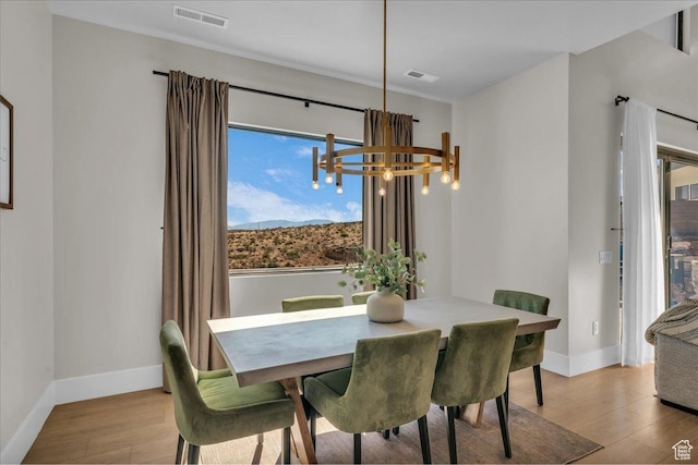 1003 N Grand Heights Dr, St George, UT 84770 - dining room featuring a chandelier, light wood-style flooring, and baseboards