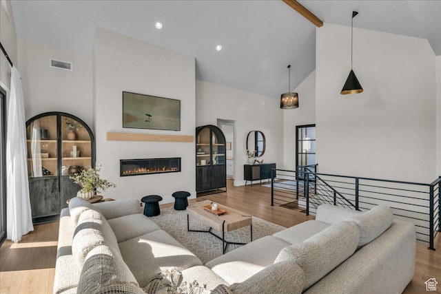 1003 N Grand Heights Dr, St George, UT 84770 - living room featuring high vaulted ceiling, beam ceiling, wood finished floors, and a glass covered fireplace