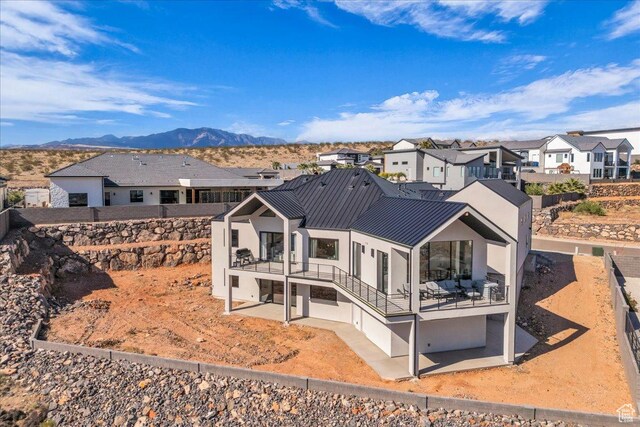 1003 N Grand Heights Dr, St George, UT 84770 - rear view of house with a patio area, a residential view, a standing seam roof, stucco siding, and a mountain view