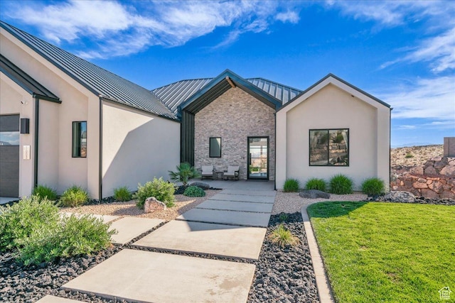 1003 N Grand Heights Dr, St George, UT 84770 - view of front of home featuring a standing seam roof, a front lawn, metal roof, stucco siding, and stone siding