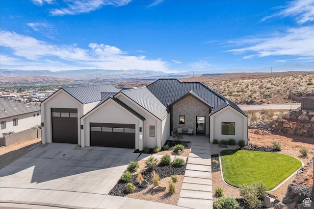 1003 N Grand Heights Dr, St George, UT 84770 - view of front of home featuring a garage, driveway, a mountain view, stucco siding, and metal roof