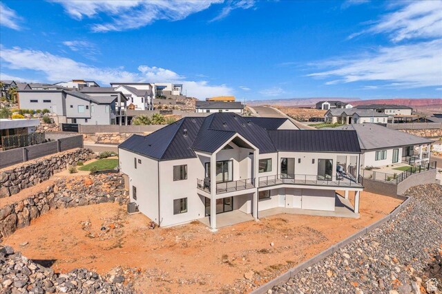 1003 N Grand Heights Dr, St George, UT 84770 - back of property with stucco siding, a residential view, and a fenced backyard