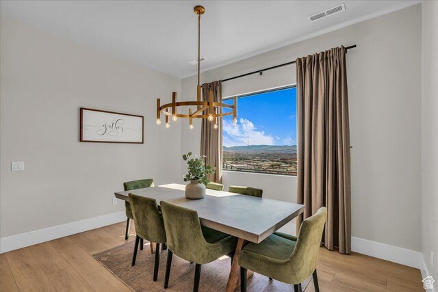 1003 N Grand Heights Dr, St George, UT 84770 - dining space with a chandelier, baseboards, and light wood finished floors