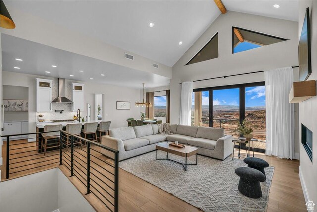 1003 N Grand Heights Dr, St George, UT 84770 - living room featuring wood finished floors, beamed ceiling, high vaulted ceiling, a chandelier, and recessed lighting