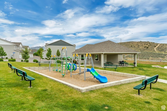community playground featuring a yard and a mountain view