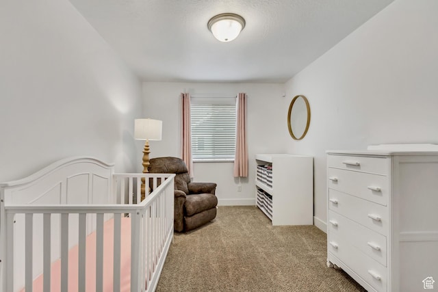 bedroom featuring carpet and a crib