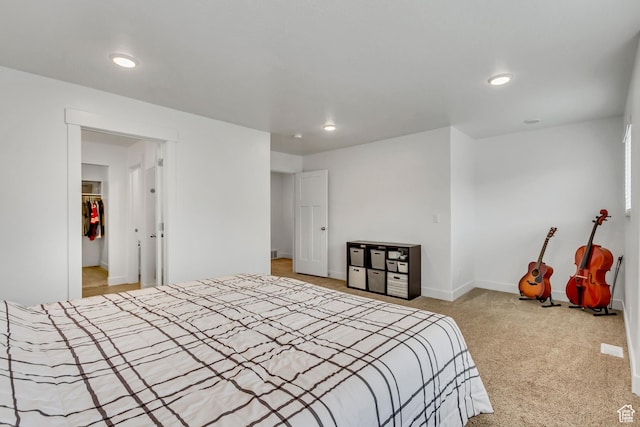 bedroom featuring recessed lighting, light colored carpet, and baseboards