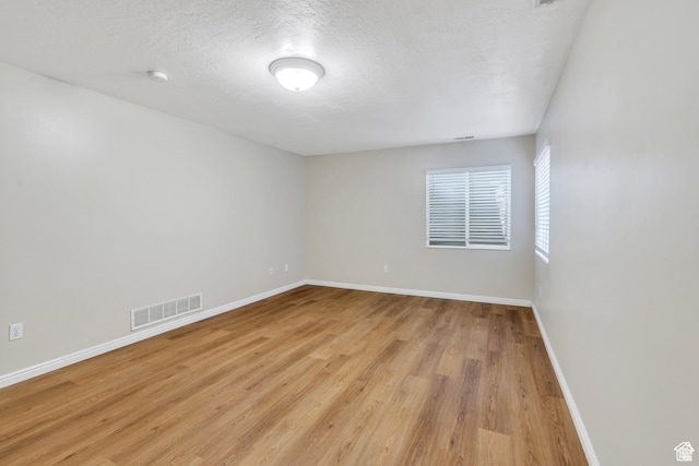1140 E Elgin Ave S, Millcreek, UT 84106 - empty room featuring light wood finished floors, baseboards, a smoke detector, and a textured ceiling