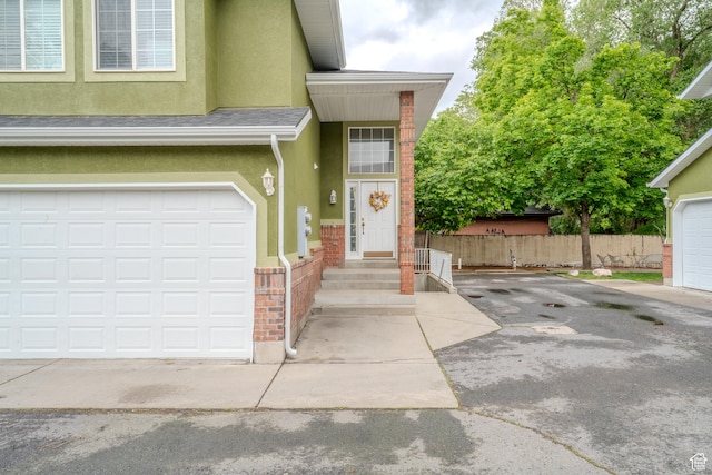 1140 E Elgin Ave S, Millcreek, UT 84106 - property entrance featuring stucco siding, fence, driveway, and brick siding