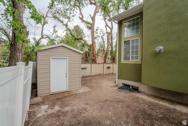 1140 E Elgin Ave S, Millcreek, UT 84106 - view of patio featuring a storage unit, a fenced backyard, and an outbuilding