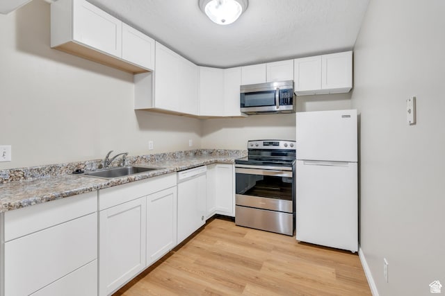 1140 E Elgin Ave S, Millcreek, UT 84106 - kitchen with appliances with stainless steel finishes, a sink, white cabinetry, and light wood-style flooring