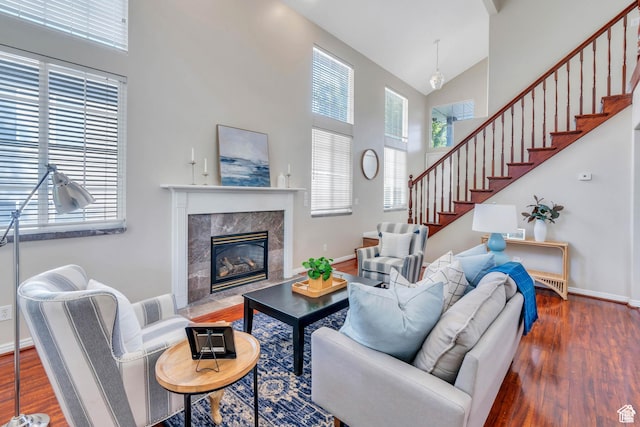 1140 E Elgin Ave S, Millcreek, UT 84106 - living room with high vaulted ceiling, wood finished floors, stairs, a fireplace, and baseboards