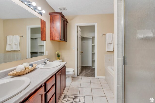 1140 E Elgin Ave S, Millcreek, UT 84106 - bathroom with tile patterned floors, a walk in closet, toilet, and double vanity