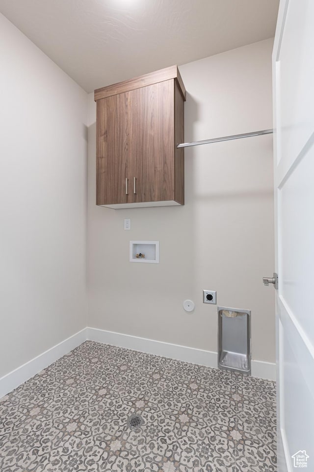 laundry area with hookup for an electric dryer, cabinet space, baseboards, hookup for a washing machine, and tile patterned floors