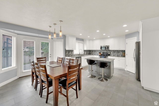 dining area with baseboards, recessed lighting, and light tile patterned flooring