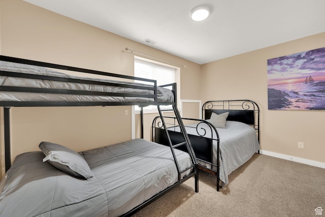 carpeted bedroom featuring baseboards