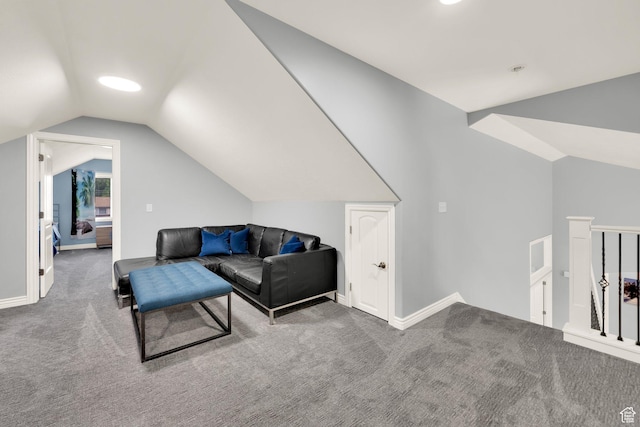 carpeted living area featuring vaulted ceiling and baseboards