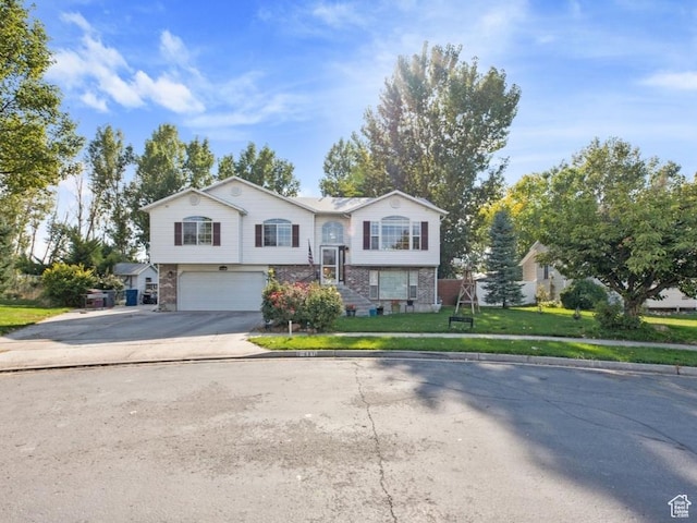 681 W 410 N, American Fork, UT 84003 - raised ranch with an attached garage, concrete driveway, brick siding, and a front lawn