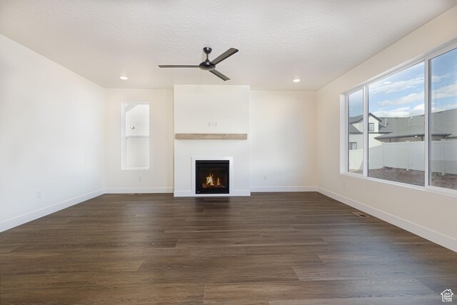 1262 N 3625 W Cir W, Cedar City, UT 84721 - unfurnished living room featuring a lit fireplace, ceiling fan, dark wood-style flooring, baseboards, and recessed lighting