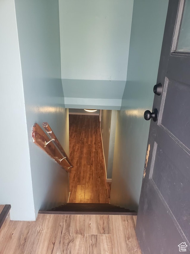 stairs featuring wood finished floors