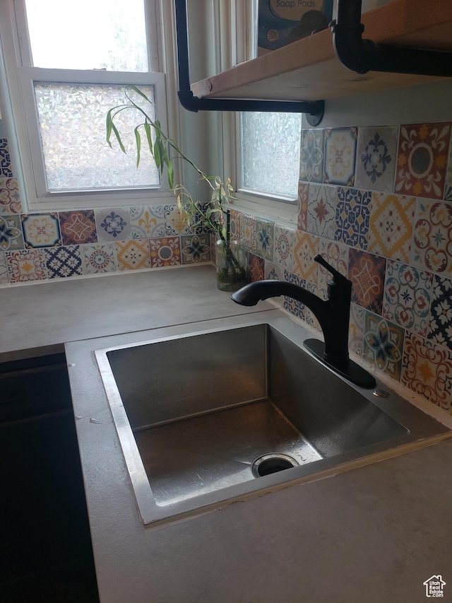 kitchen view of a sink and light countertops