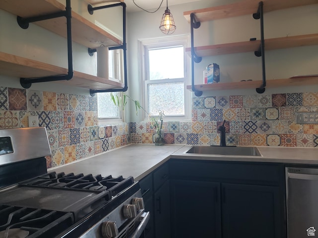 kitchen with stainless steel appliances, a sink, open shelves, tasteful backsplash, and light countertops