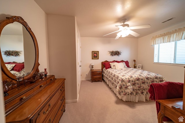 bedroom featuring light carpet, baseboards, and a ceiling fan