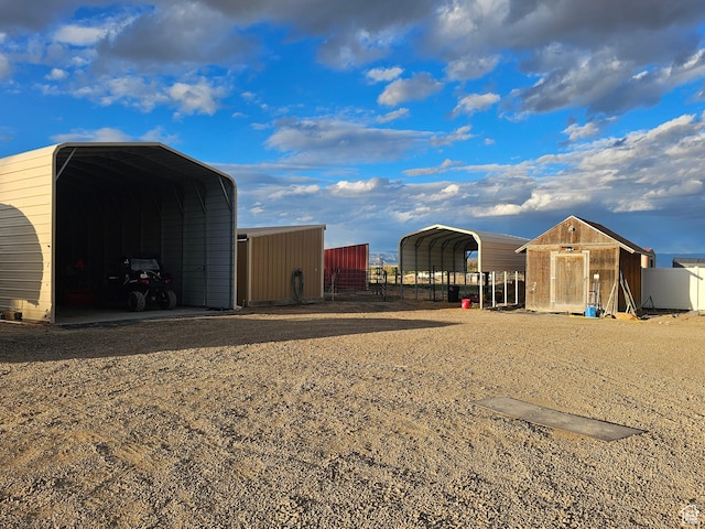 view of outdoor structure featuring a carport and fence