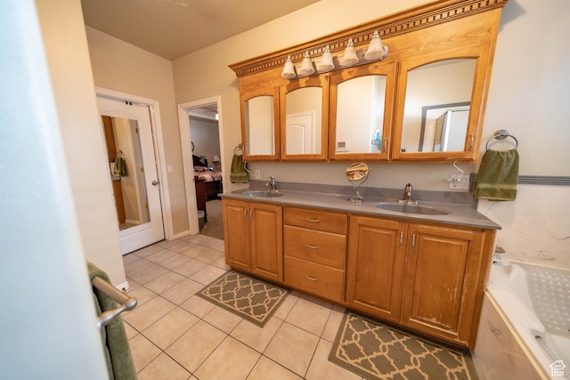 full bathroom featuring tile patterned floors, double vanity, and a tub to relax in