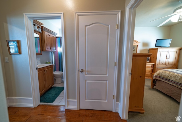hall featuring baseboards and wood finished floors