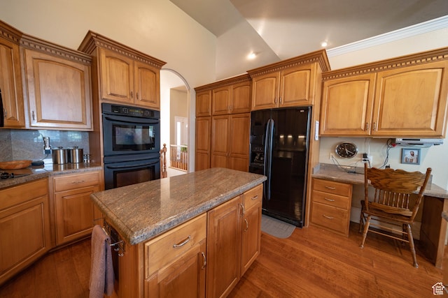 kitchen with black appliances, tasteful backsplash, wood finished floors, brown cabinets, and recessed lighting