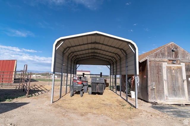 view of parking featuring a detached carport and fence
