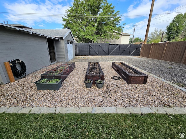 44 S 700 E, Provo, UT 84606 - fenced backyard featuring a vegetable garden and a garage