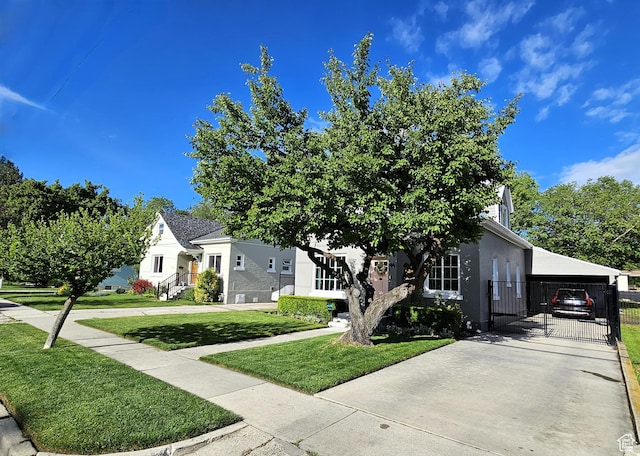 44 S 700 E, Provo, UT 84606 - view of property hidden behind natural elements with concrete driveway, stucco siding, and an attached carport