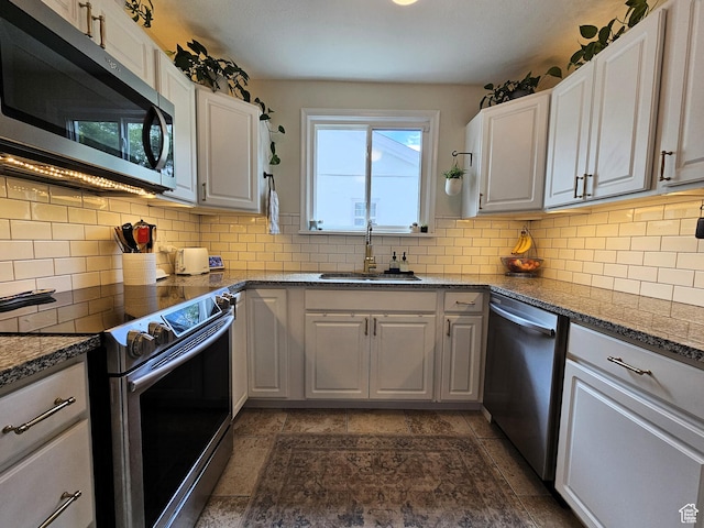 44 S 700 E, Provo, UT 84606 - kitchen featuring stainless steel appliances, a sink, tasteful backsplash, white cabinets, and dark stone countertops