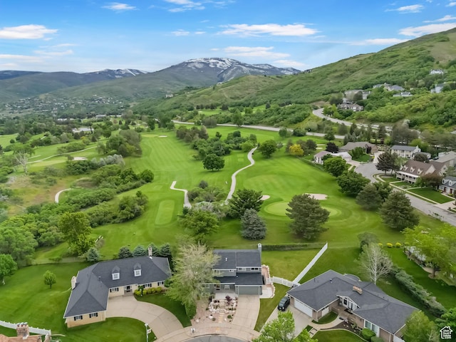 bird's eye view of mountains and a golf club