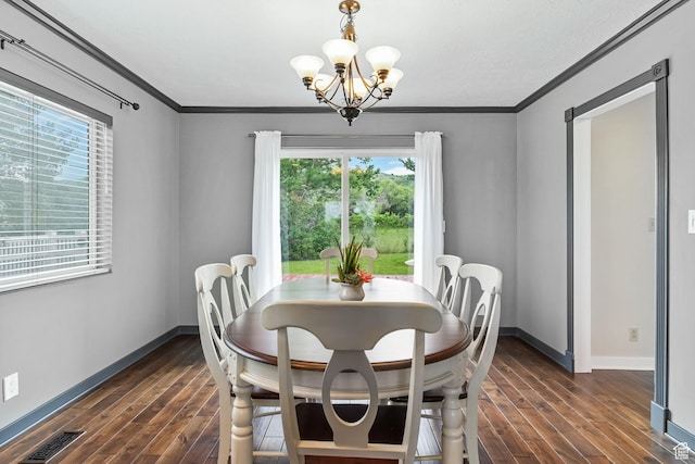 dining space with dark wood-style floors, baseboards, crown molding, and a chandelier