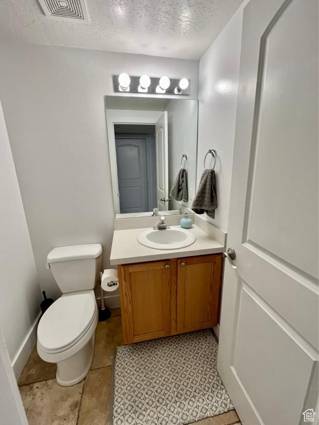 1347 S 1370 E, Provo, UT 84606 - bathroom with toilet, vanity, a textured ceiling, and baseboards