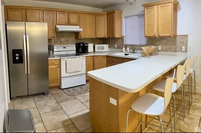 1347 S 1370 E, Provo, UT 84606 - kitchen featuring white appliances, under cabinet range hood, a peninsula, and light countertops
