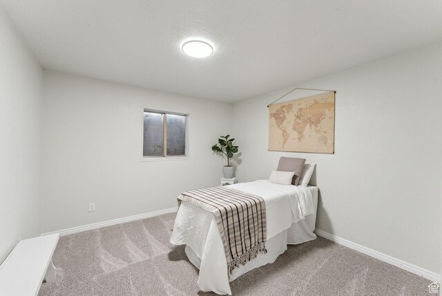 carpeted bedroom with baseboards