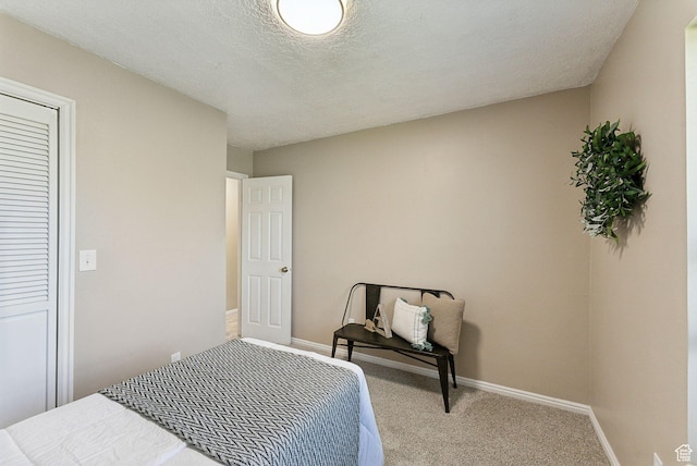 bedroom featuring carpet floors and baseboards